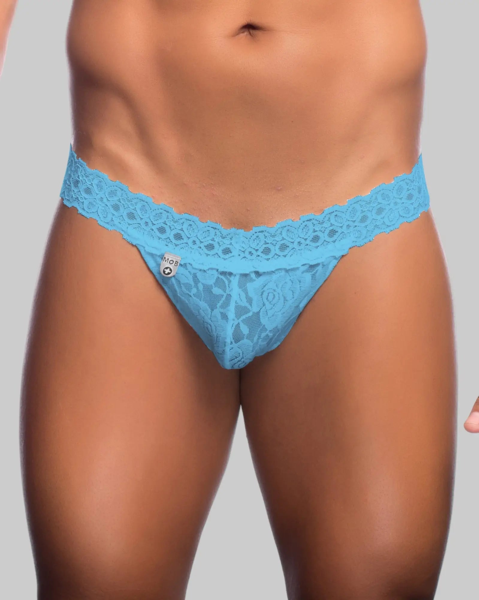 Light blue lace thong with delicate floral pattern and branded tag for men by MOB men’s lace waist thong