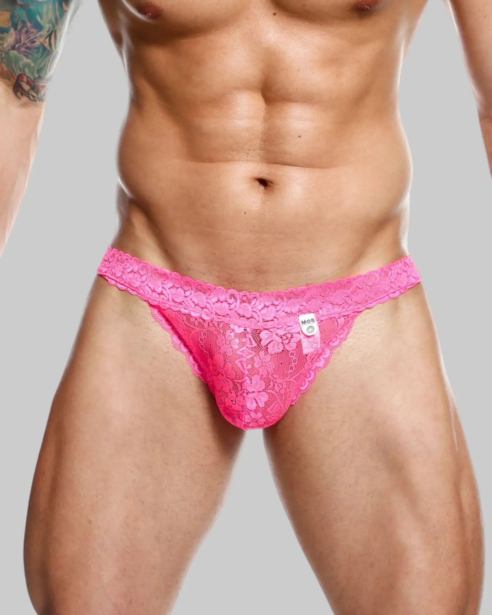 Vibrant pink lace waist thong for men featuring intricate floral patterns and delicate sheer design by mob
