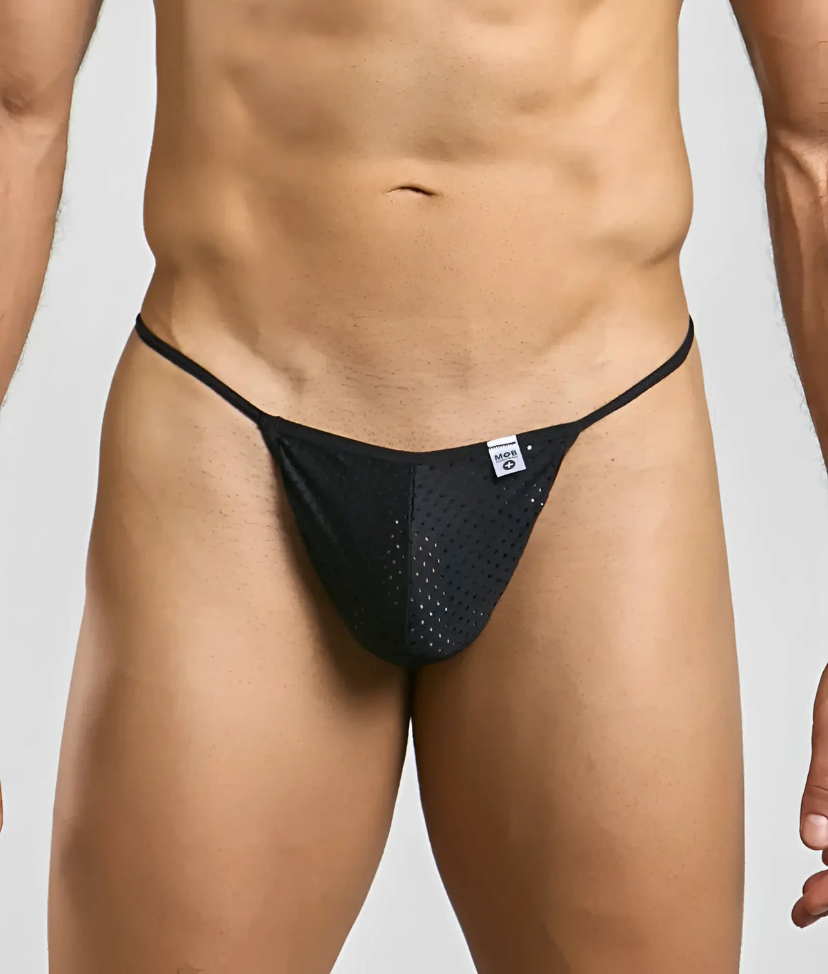 Black mesh microfiber thong with thin elastic waistband and white brand tag for men from MOB sexy g-string collection