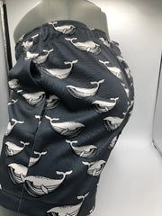 Dark gray moby dick shorts with a repeating white whale pattern swim trunks perfect for beachwear