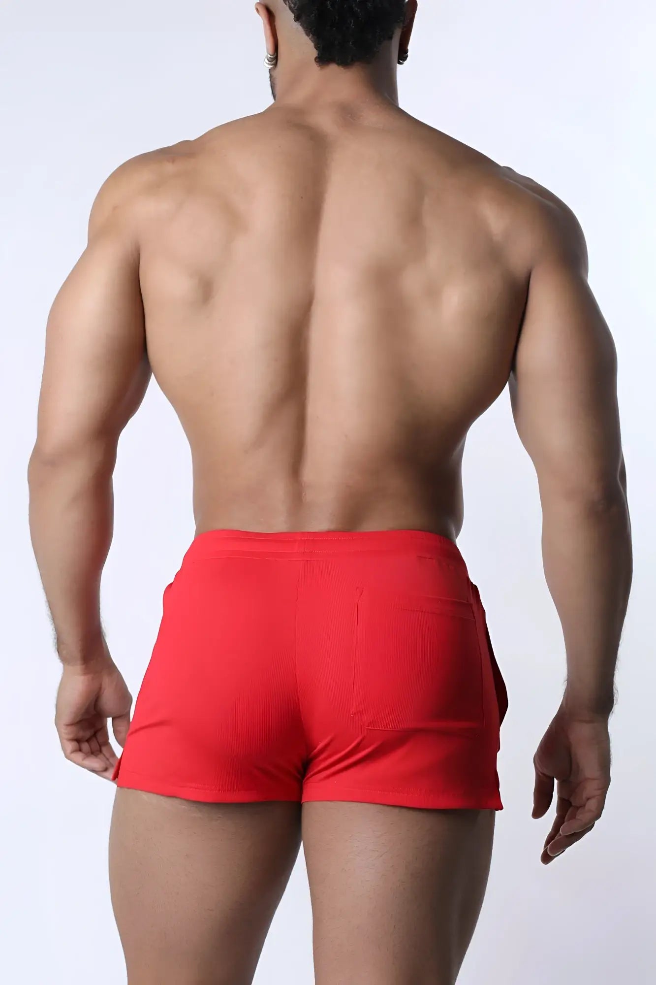 Red muzzle up athletic shorts with a ribbed texture and side pockets for comfortable sportswear use
