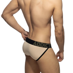 Beige addict brand naked feeling bikini brief with black elastic waistband and side trim in soft fabric