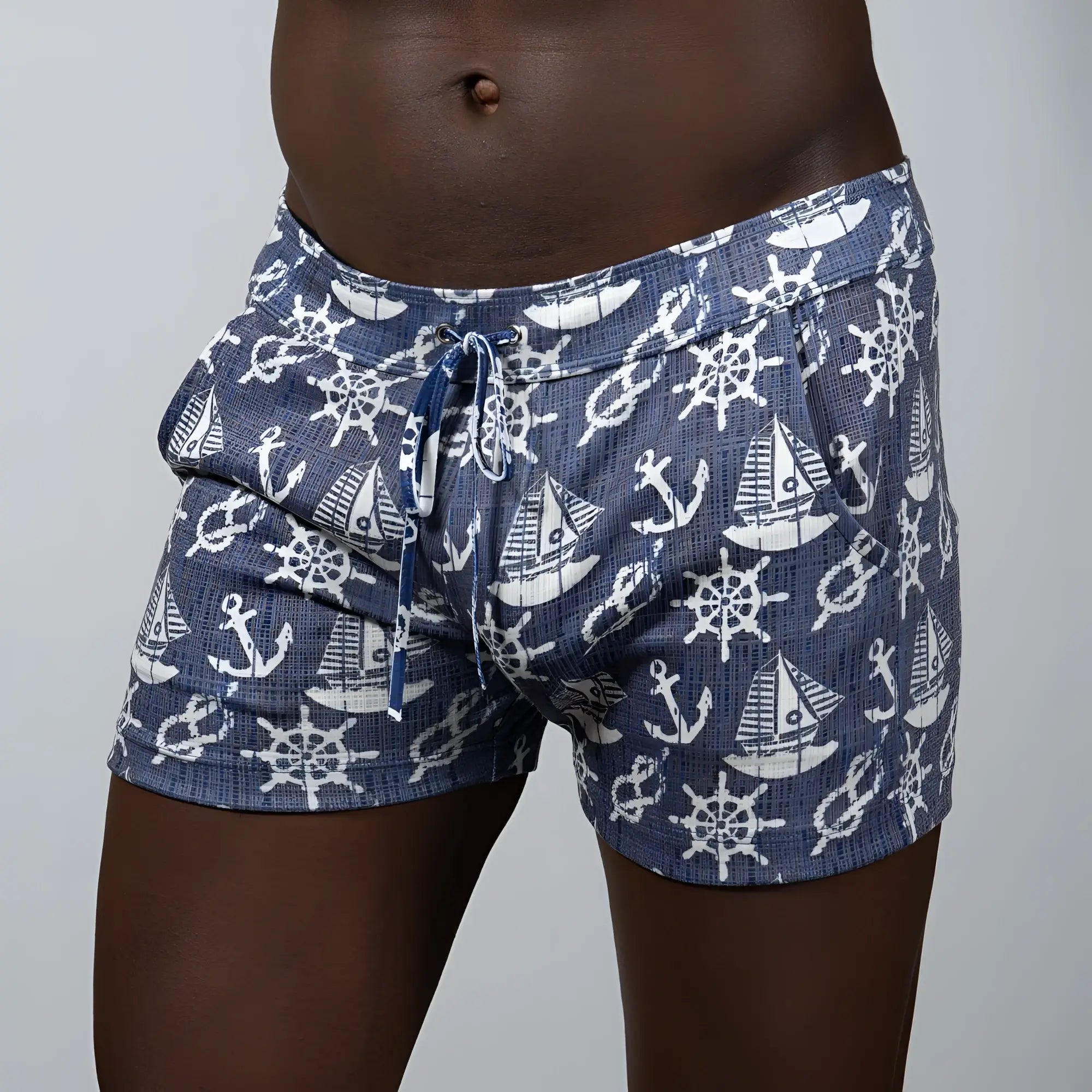 Nautical linen texture shorts in navy blue linen fabric with white anchor and ship wheel patterns and elastic waistband