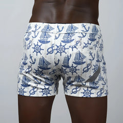 White nautical linen texture shorts with navy sailboats anchors and ship wheels swim trunks pattern