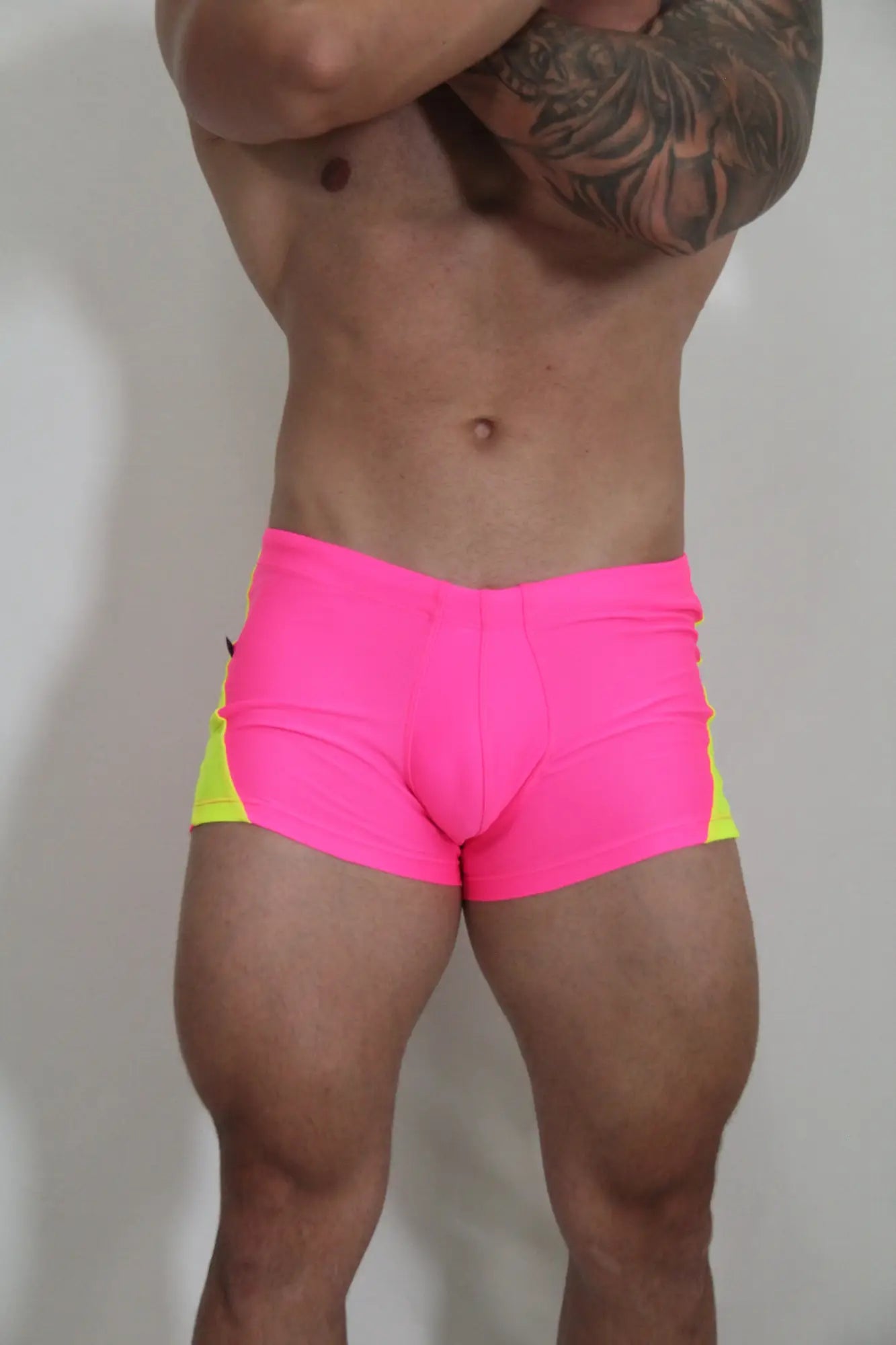Neon curved sq cut trunk bright pink and neon yellow athletic swim trunks with snug form fitting design