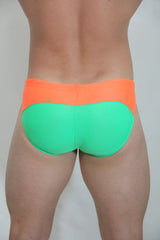 Neon curved swim brief in bright orange and neon green two-tone design for vibrant beachwear