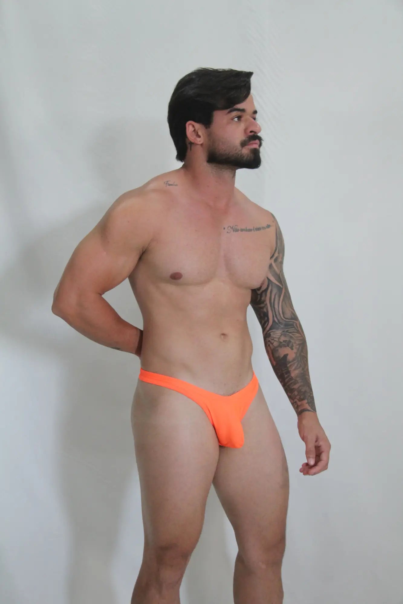 Bright orange neon swim thong with sleek minimalist design available in four colors for beachwear and swimming