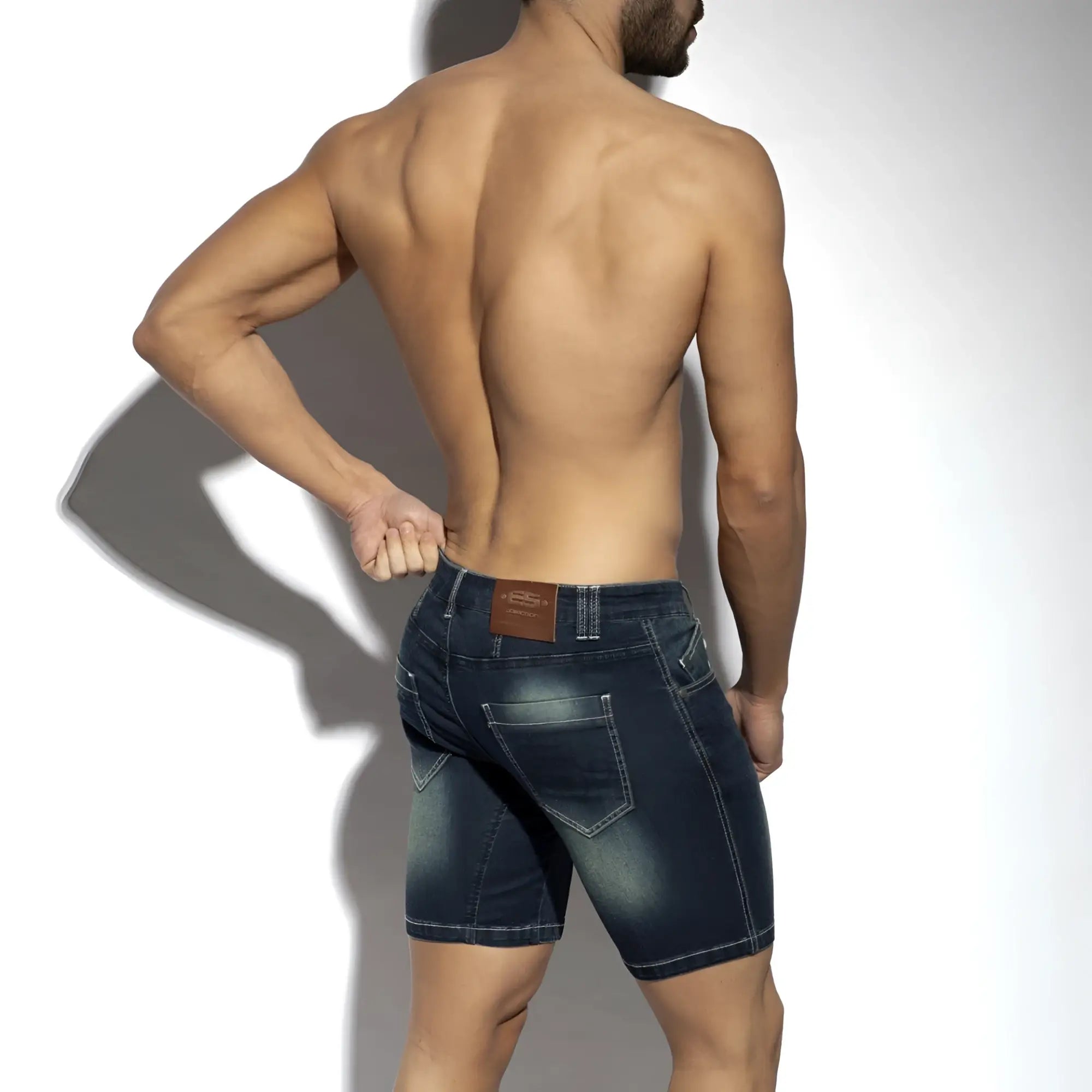 Dark blue denim bermuda jeans shorts with faded wash and stitched pockets shown from the back side