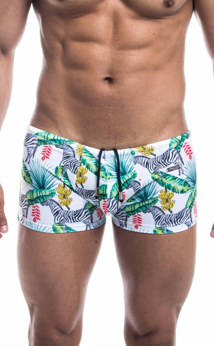 Oceanico square cut white swim trunks with vibrant tropical pattern featuring zebras green palm leaves and yellow flowers