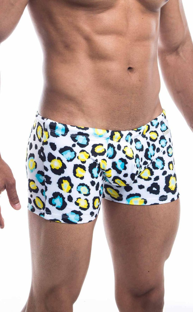 Oceanico square cut white swim trunks with bold leopard print in vibrant yellow and teal accents for beachwear