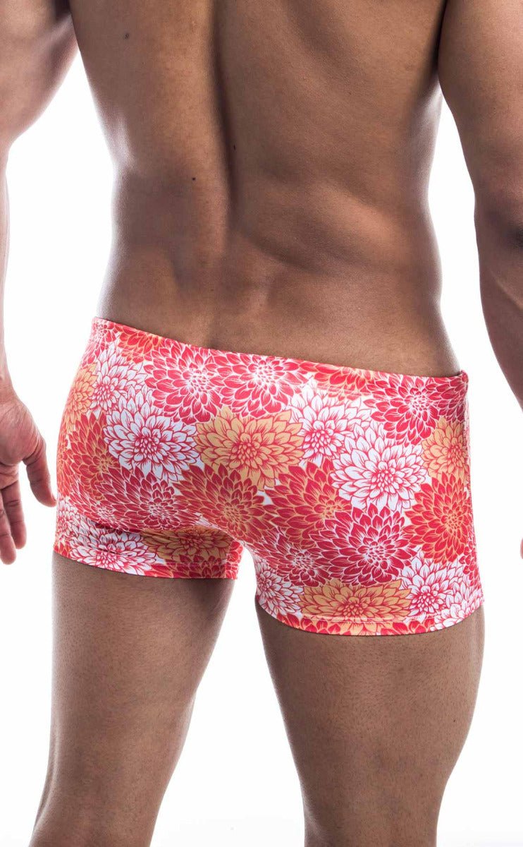 Oceanico square cut swim trunks with vibrant coral and white floral pattern and a snug high waisted cut