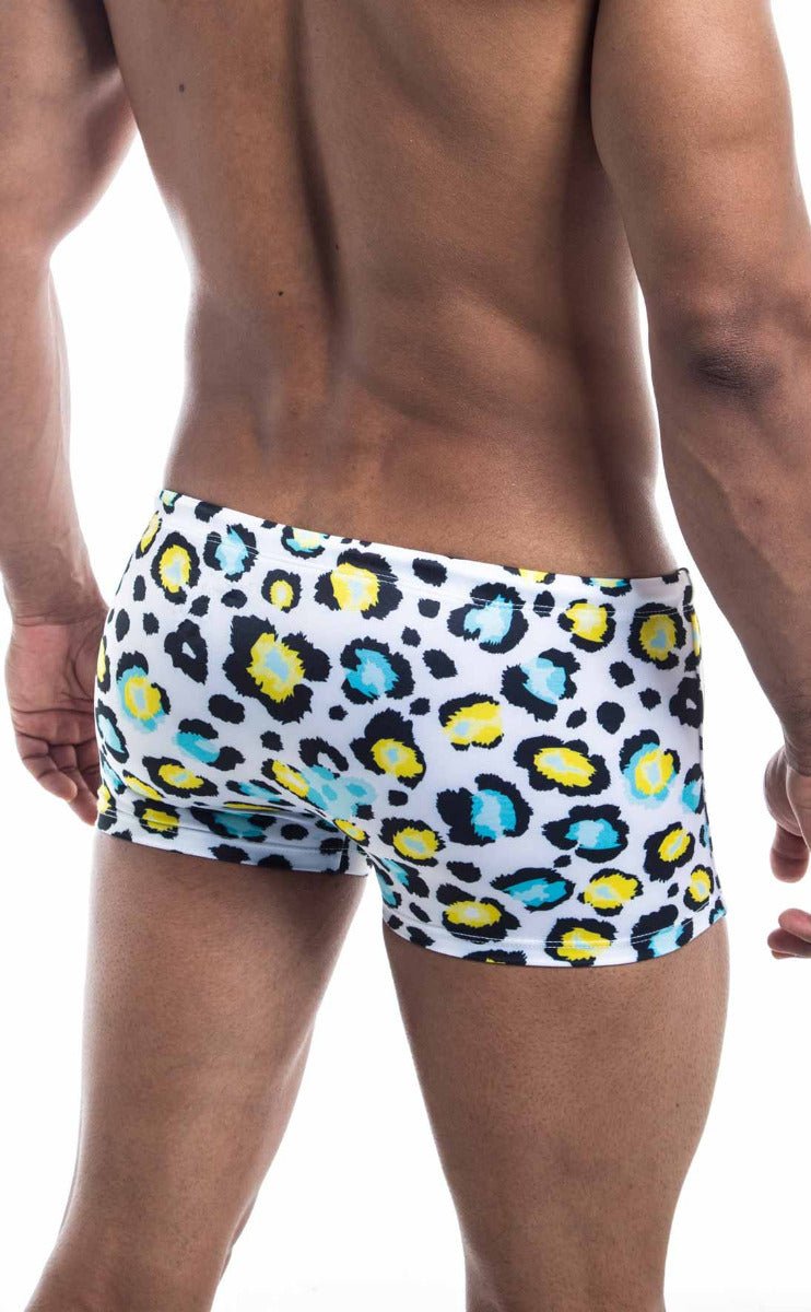 Oceanico square cut white swim trunks with bold leopard print featuring yellow and teal spots