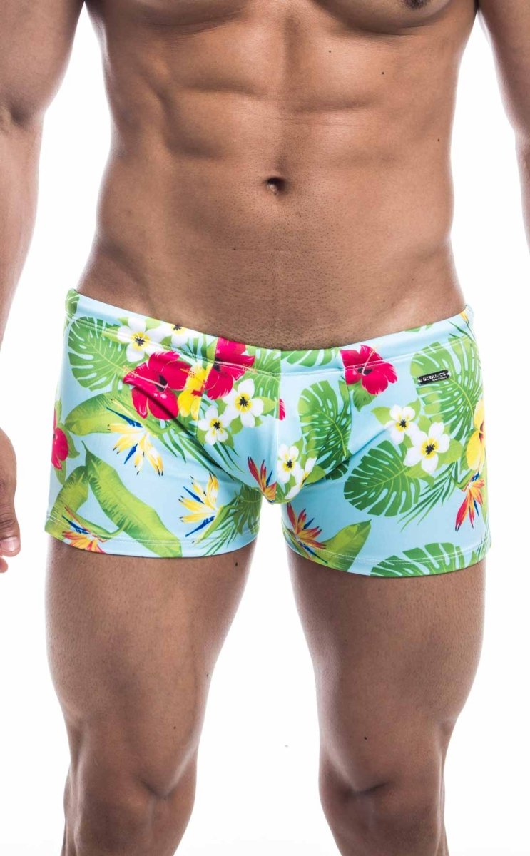 Oceanico square cut swim trunks with brightly colored tropical print in light blue green red and yellow for beachwear