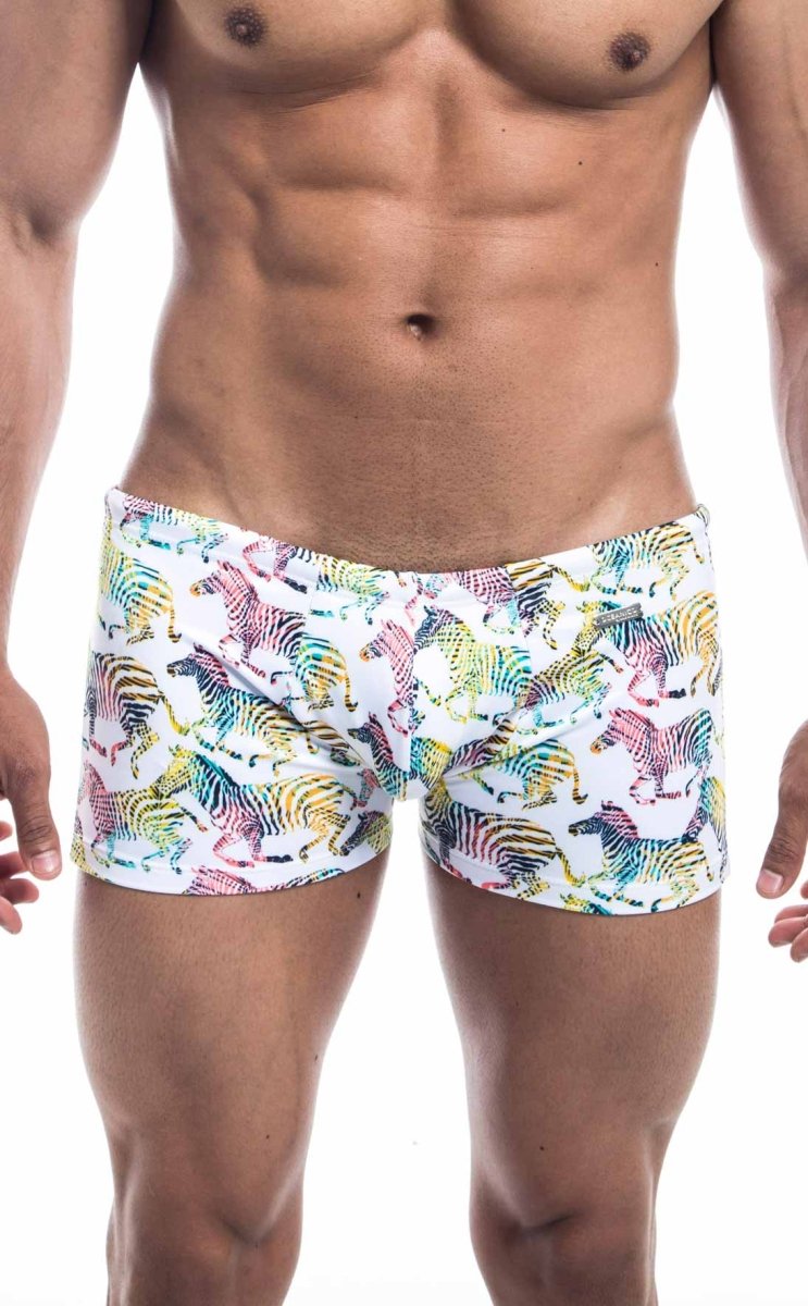 Oceanico square cut white swim trunks with a vibrant multicolored rainbow zebra pattern for beachwear