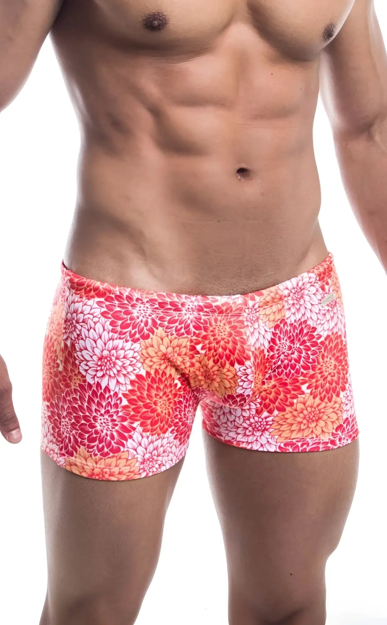 Oceanico square cut swim trunks with vibrant coral and white floral pattern and a snug form fitting design
