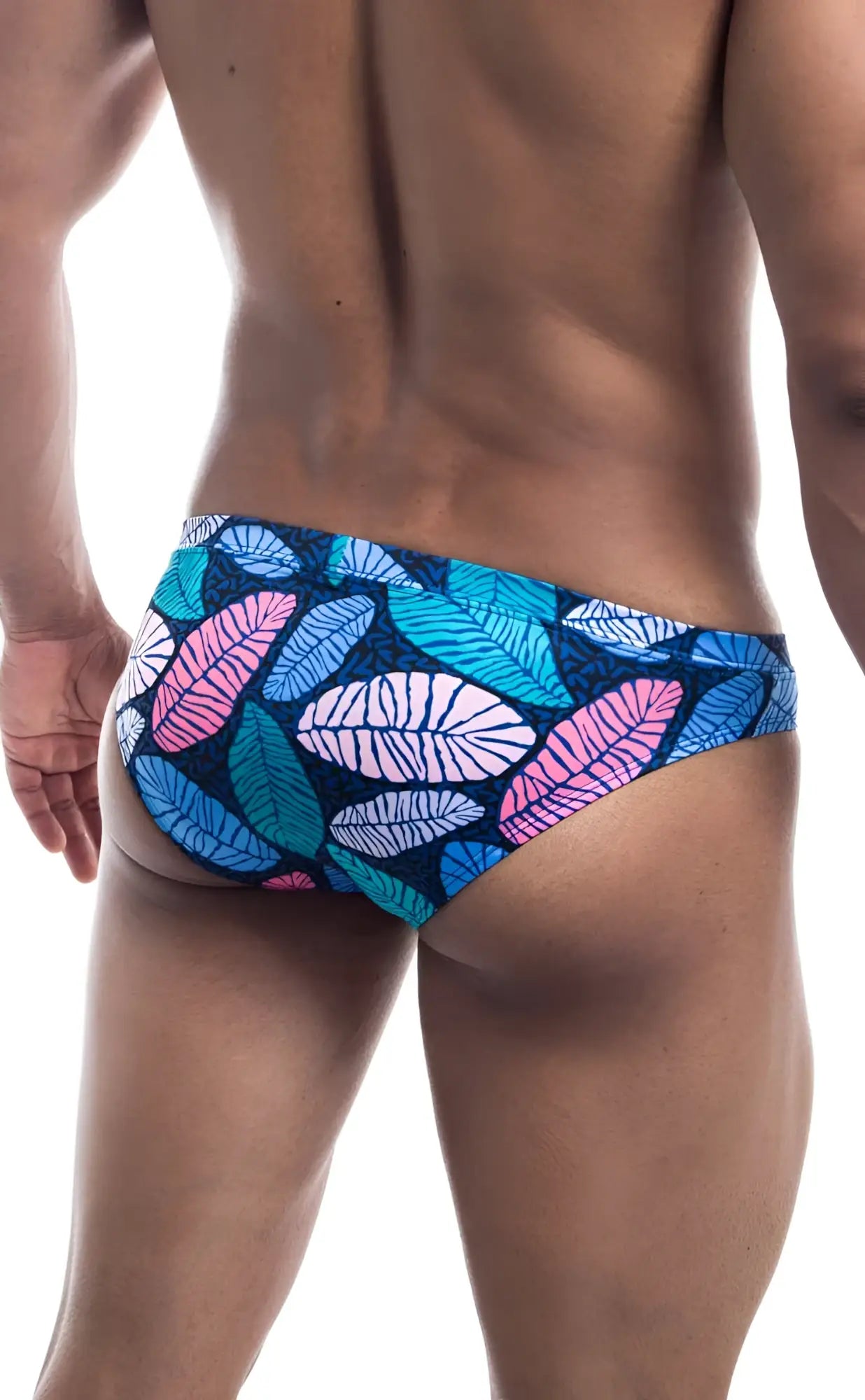 Oceanico swim bikini vibrant tropical leaf-patterned swim trunks in pink teal and white on dark blue base