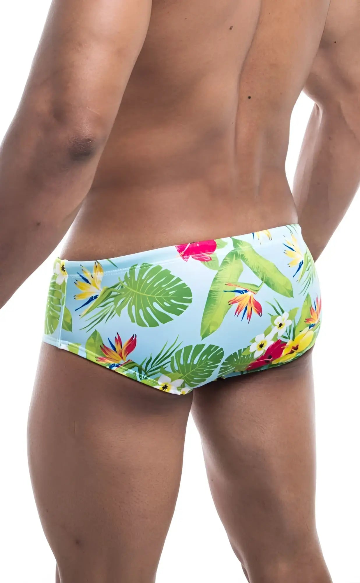 Oceanico swim brief swim trunks in light blue with green monstera leaves and tropical bird of paradise flowers