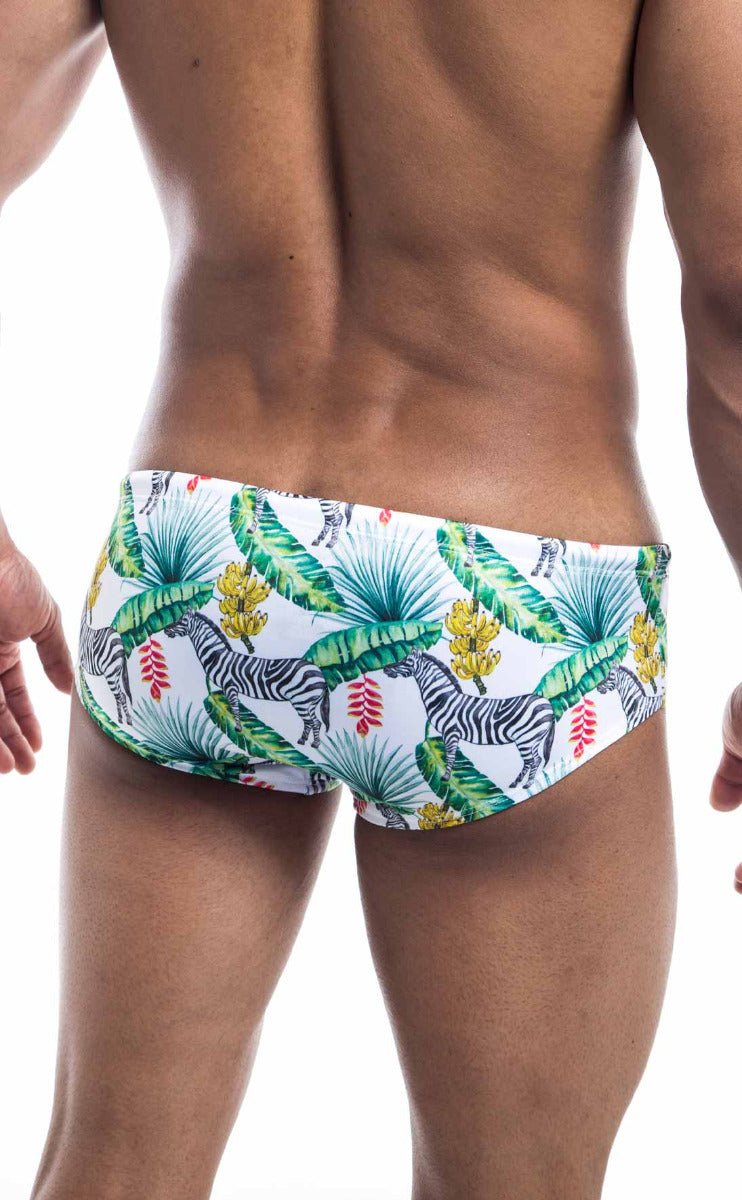 Oceanico swim brief in white with vibrant tropical pattern of green palm leaves yellow bananas red flowers and zebras