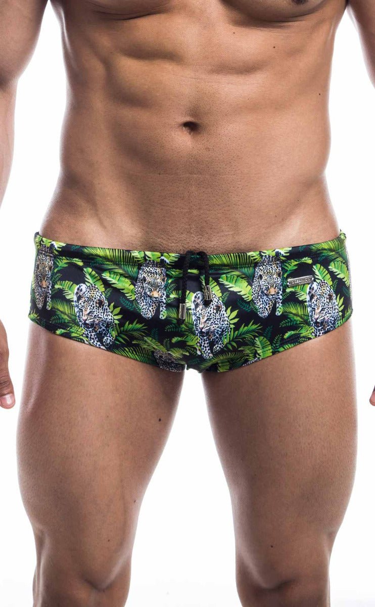 Oceanico swim brief featuring green and black fabric with a vibrant jungle pattern and white-spotted leopards