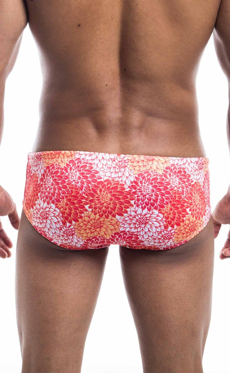 Oceanico swim brief featuring vibrant red and orange floral-patterned fabric designed for comfortable swimwear use