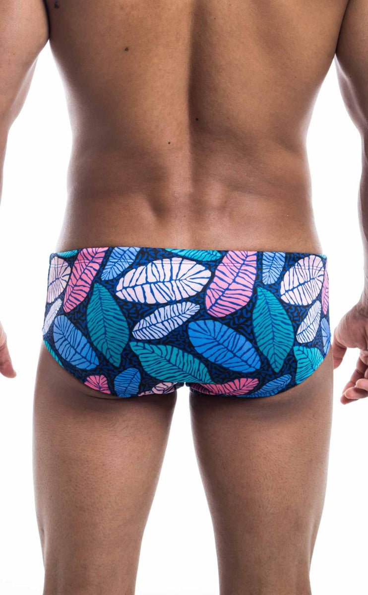Oceanico swim brief featuring vibrant blue pink and white leaf-patterned swim trunks on a dark navy base