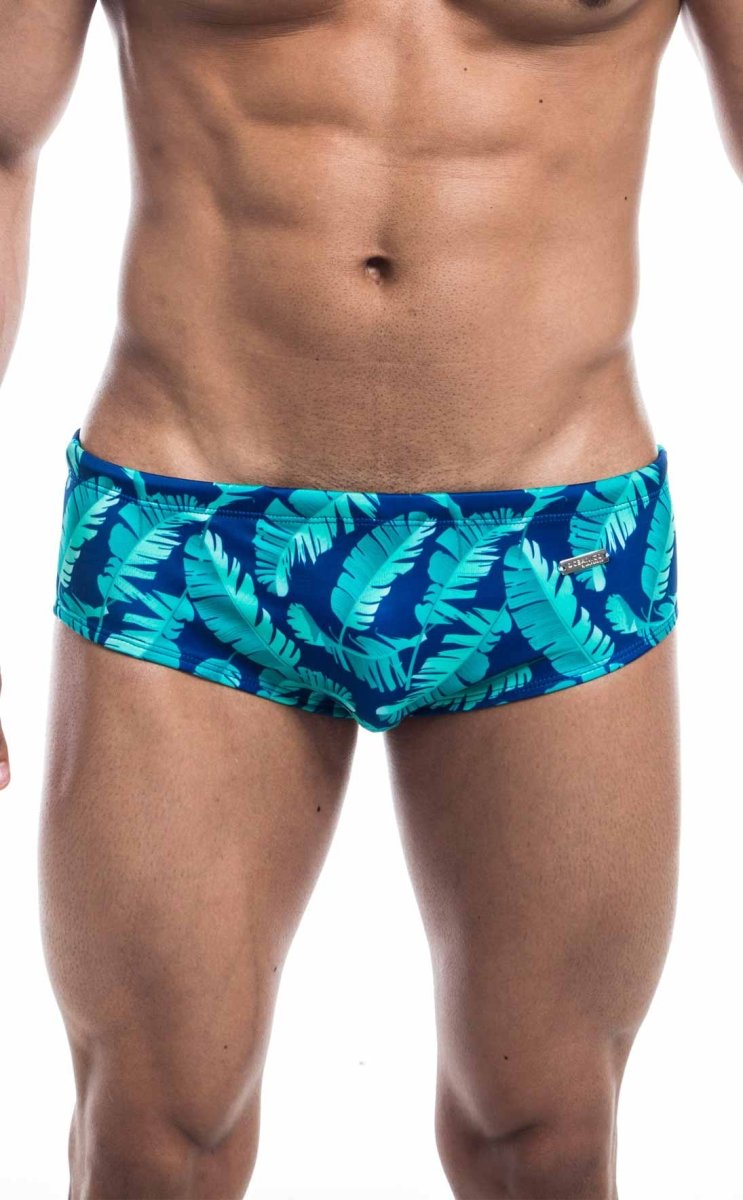 Oceanico swim brief blue swim trunks with vibrant turquoise tropical leaf pattern for beach and pool use