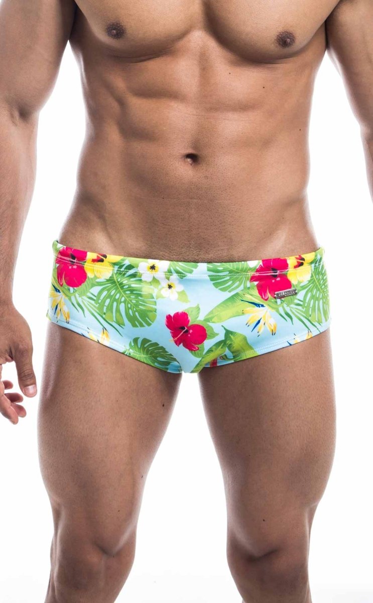 Oceanico swim brief brightly colored light blue tropical print swim trunks with bold red hibiscus flowers and green monstera leaves