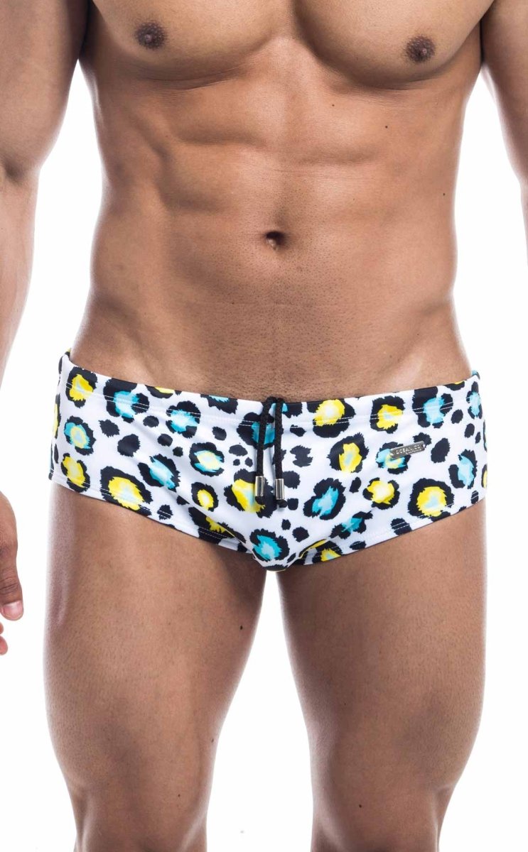Oceanico swim brief in white swim trunks with bold leopard print yellow and teal spots and black drawstring waistband