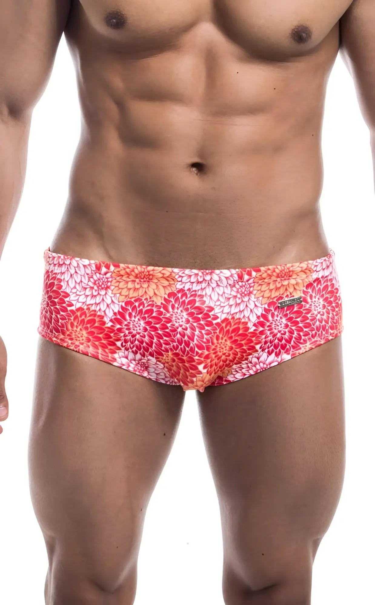 Oceanico swim brief featuring vibrant floral-patterned swim trunks in pink red and orange on a white base