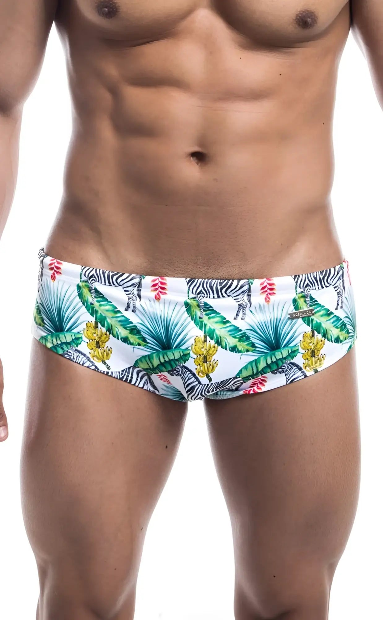 White oceanico swim brief trunks with vibrant tropical pattern of green palm leaves yellow bananas pink flowers and zebras