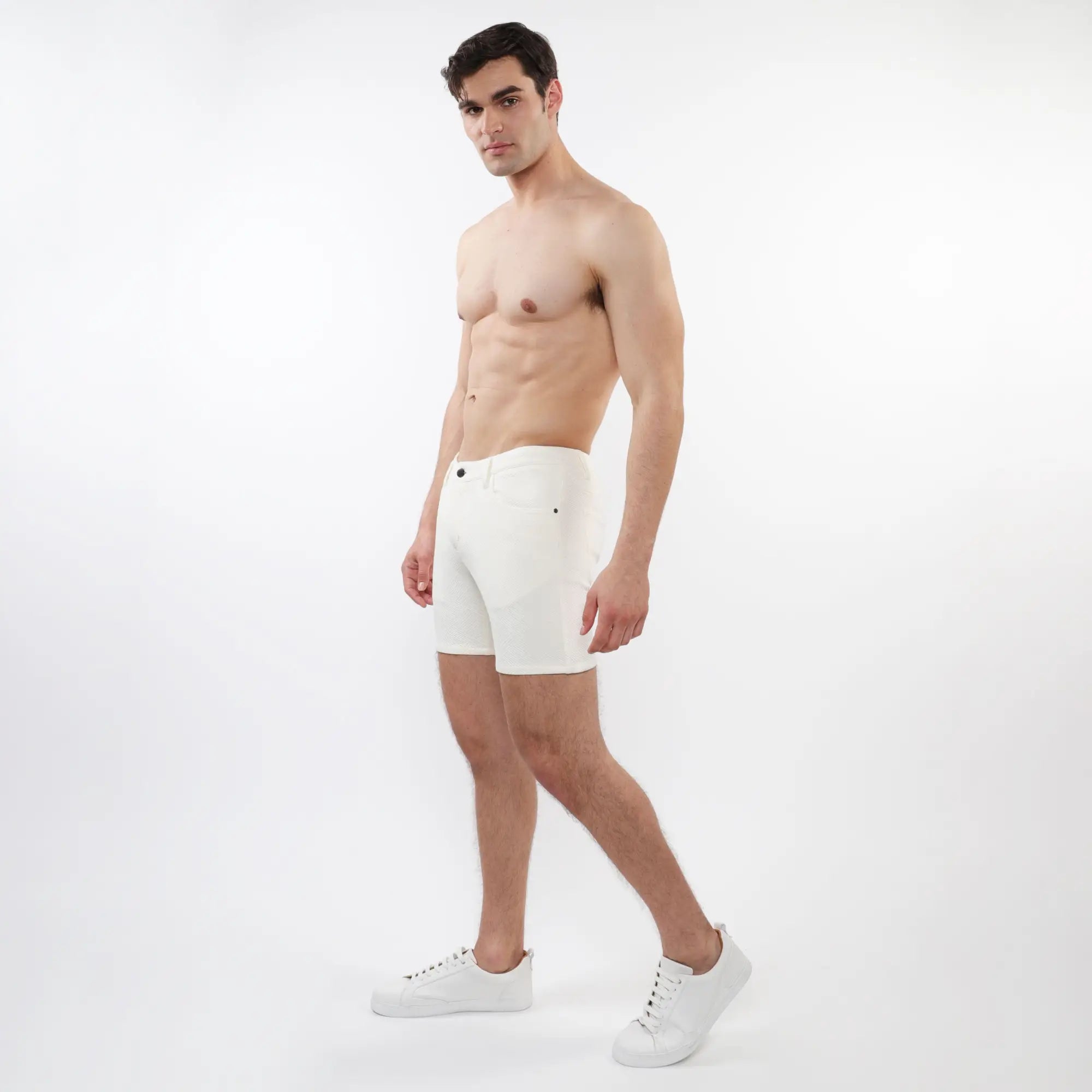 White men’s briefs with parquet jacquard stretch knit fabric and subtle black button accents in a sleek design