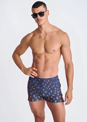Blue seersucker swim shorts with mesh lining featuring orange and yellow peacock feather patterns