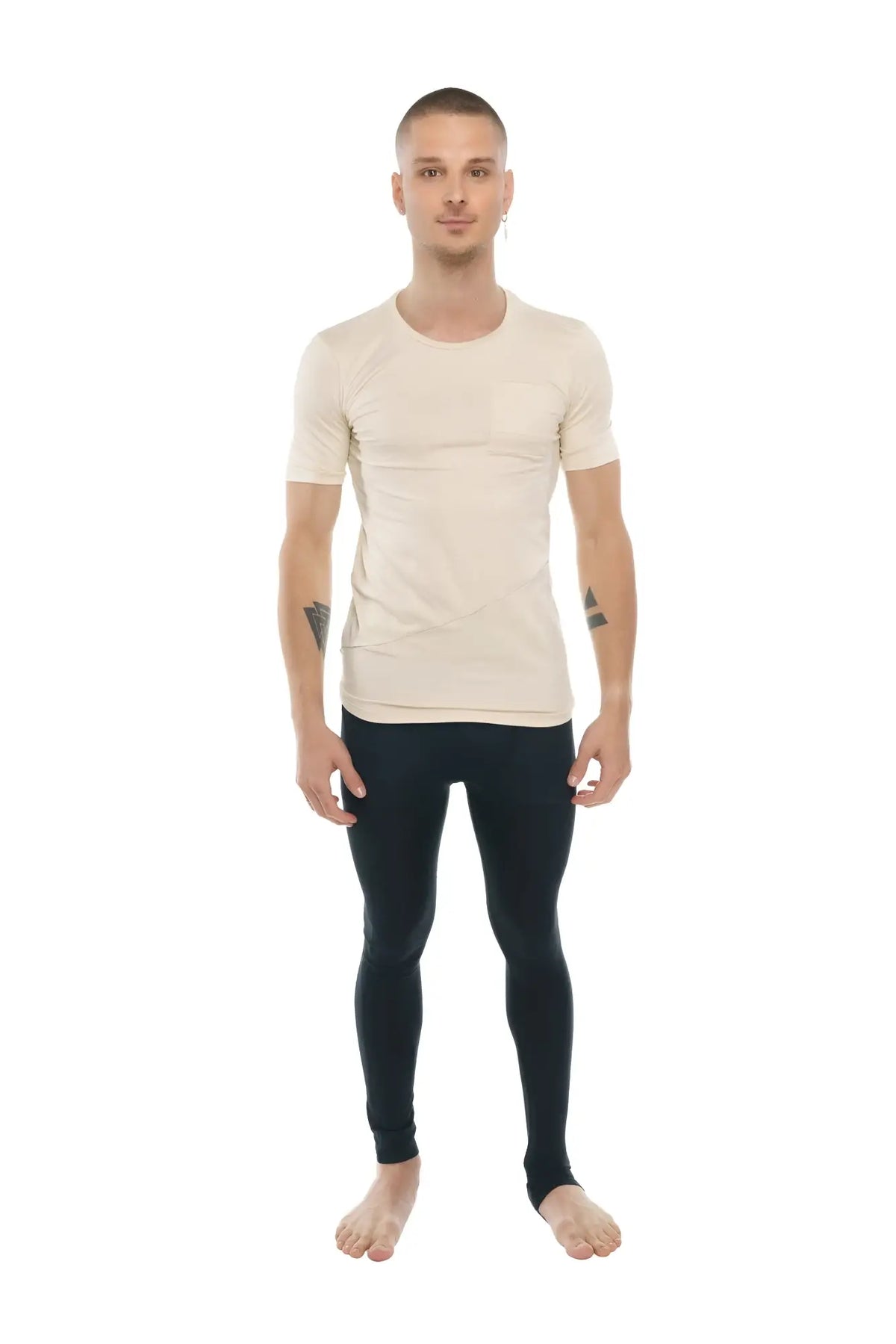 A man wearing a sand beige perfect pocket crew-neck tee paired with black form-fitting leggings shows the front side
