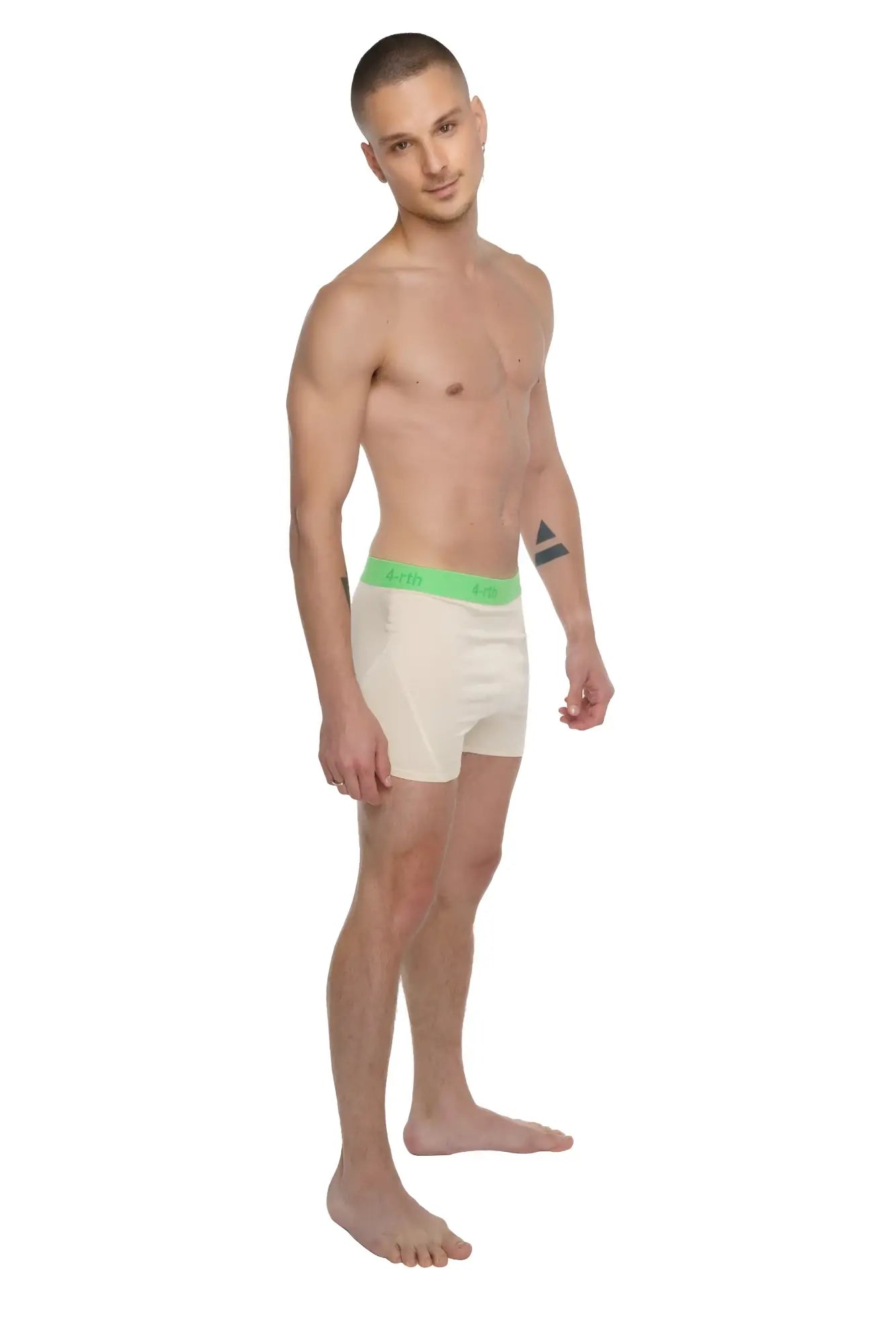Cream-colored boxer briefs with bright green elastic waistband and brand logo shown with performance yoga leggings sand beige
