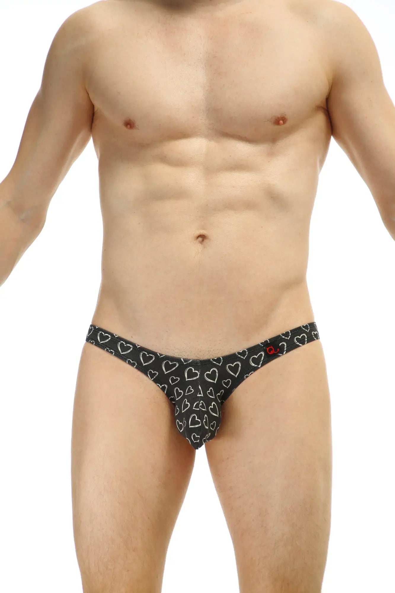 Black thong with white heart pattern from petitq bikini dumbo coeur collection showing front side design