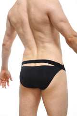 Back side of petitq bikini mardie black swim trunks in black with two horizontal elastic bands and a modern design