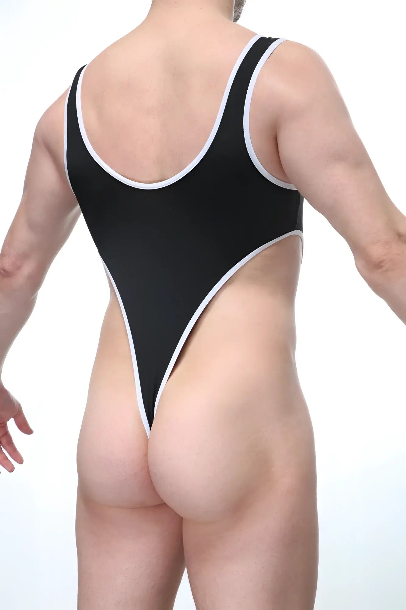 PetitQ bodythong Carbay black one-piece swimsuit with white trim along neckline armholes and leg openings front view