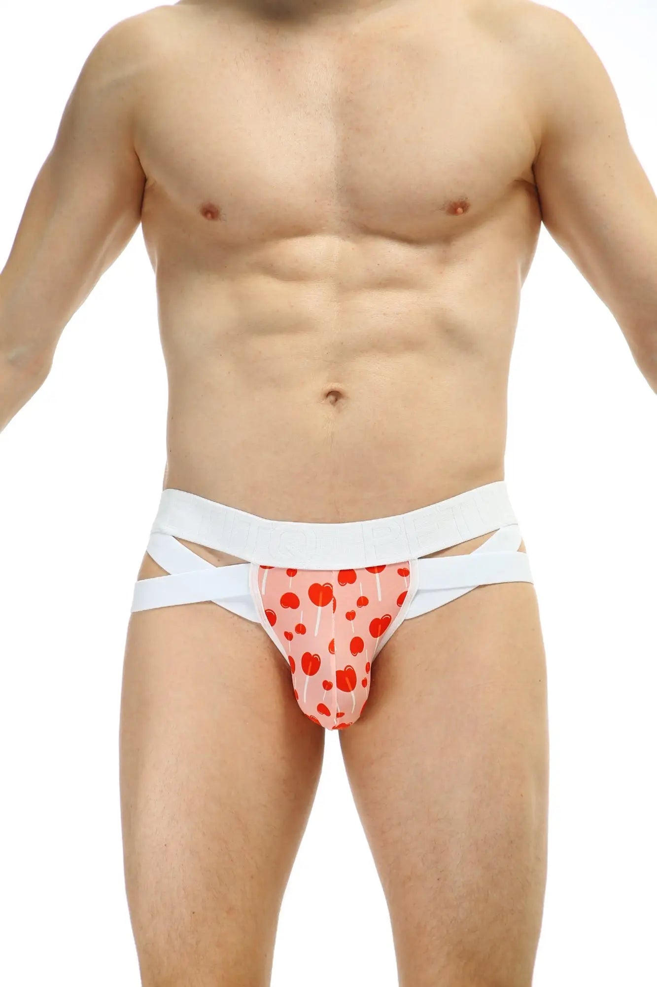 Pink heart-patterned briefs with white crisscross straps petitq jockthong bost sucette front view