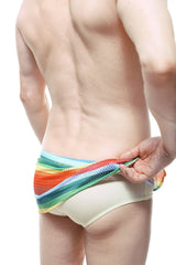 PetitQ loincloth brief rainbow mesh swim trunks with beige base and vibrant rainbow-striped horizontal bands