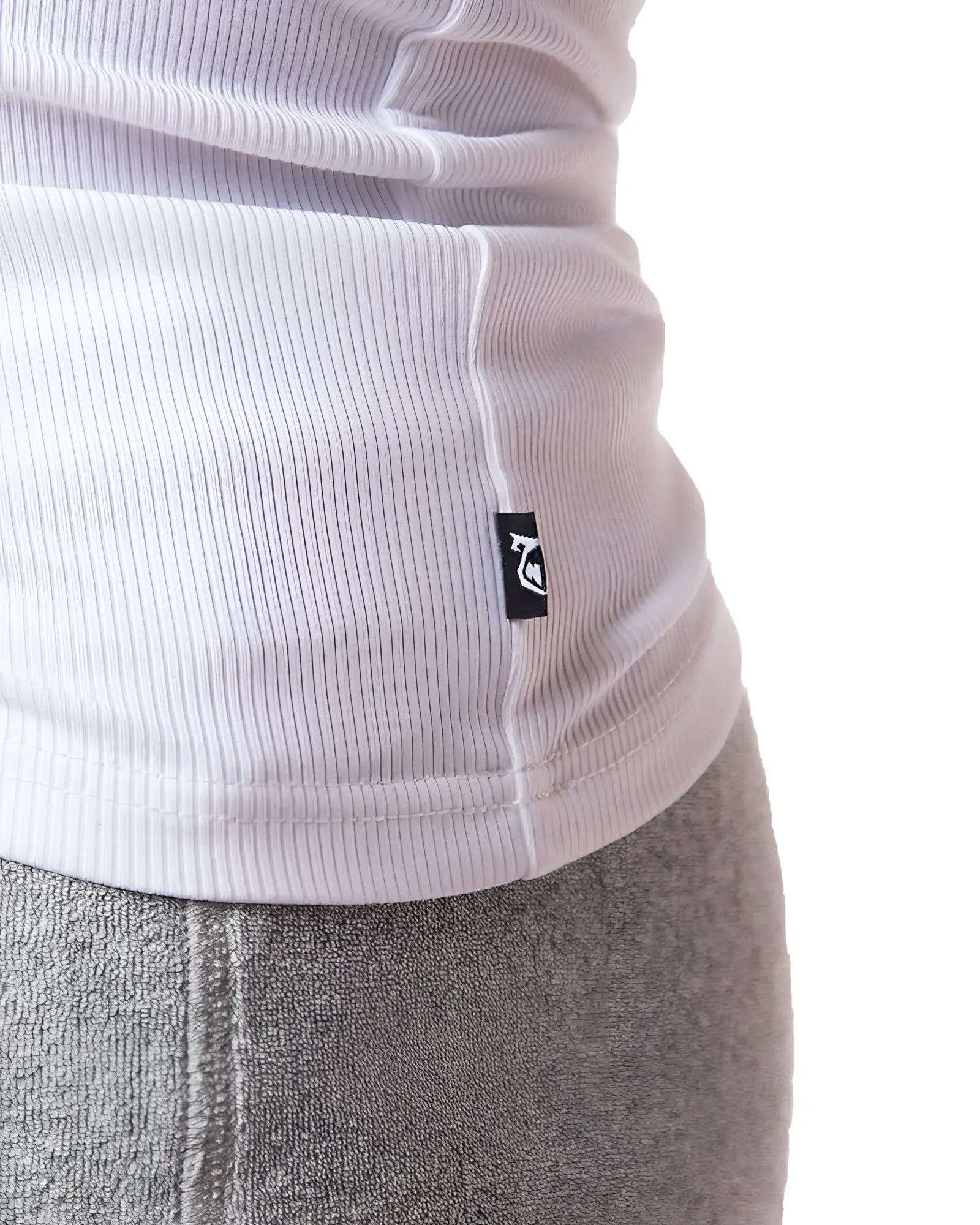 White pig rib tank top made of ribbed knit fabric with a small black logo tag at the hem