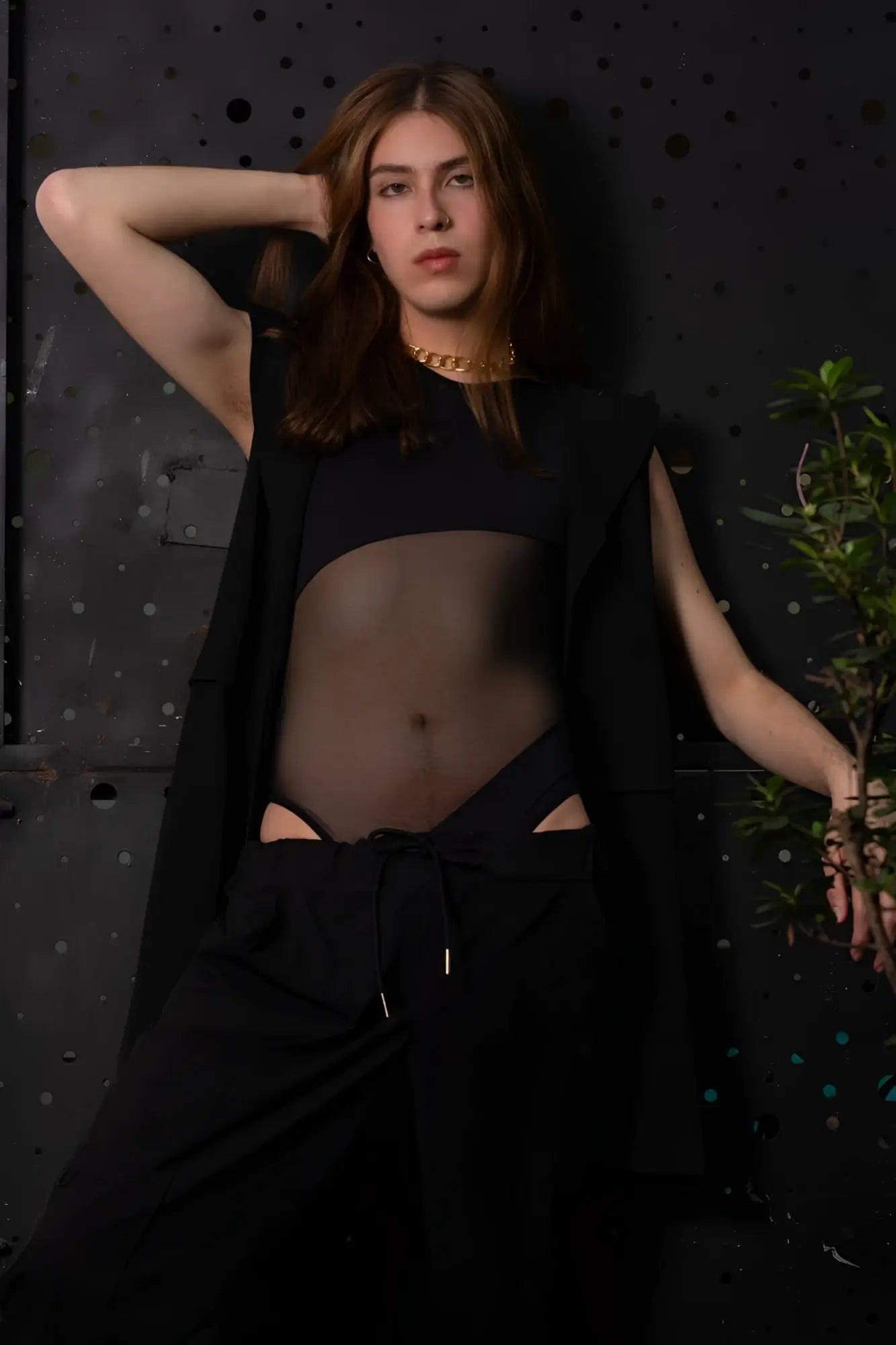 Person with long brown hair wearing a gold chain necklace and plural pl002 black bodysuit front view