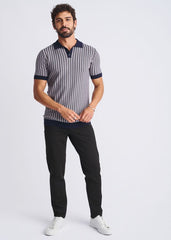 A man wearing a navy and gray textured stripes silk tencel polo with dark blue collar and sleeve cuffs