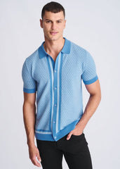Light blue short-sleeved knit polo shirt with honeycomb texture and dark blue trim on collar cuffs placket and hem