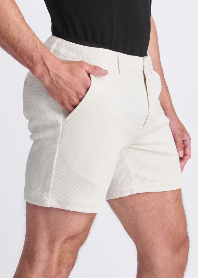 Cream-colored textured stretch knit chino shorts with tailored fit and side pockets for comfortable wear