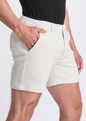 Cream-colored textured stretch knit chino shorts with tailored fit and side pockets for comfortable wear