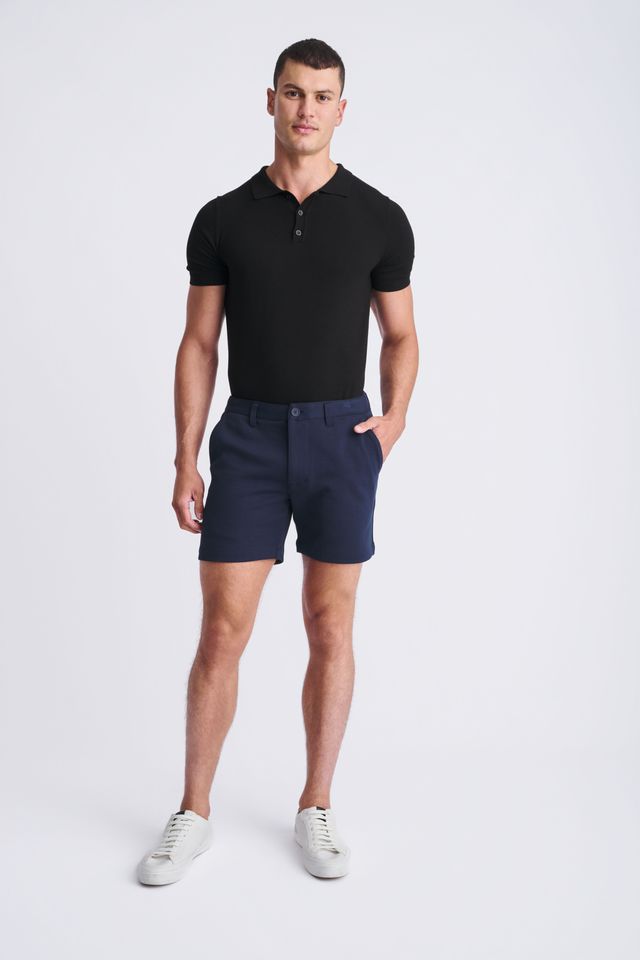 Navy blue textured stretch knit chino shorts with classic fit and button closure for casual wear
