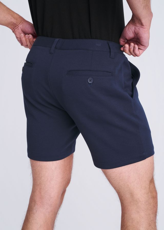 Dark navy blue textured stretch knit chino shorts with sleek tailored fit and subtle button detail on back pocket view