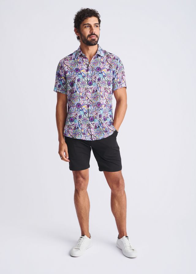 A man wearing a floral lightweight linen Tencel short-sleeved shirt in purple blue and pink