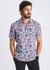 A lightweight linen tencel short-sleeved shirt with a purple blue and pink floral pattern on light lavender background