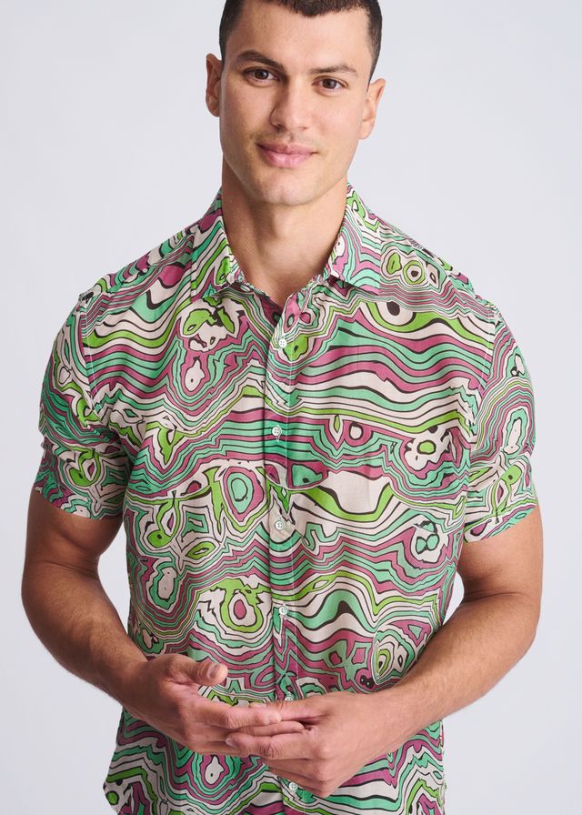 A vibrant short-sleeved button-up swirls lightweight cotton silk shirt with green pink and white psychedelic patterns
